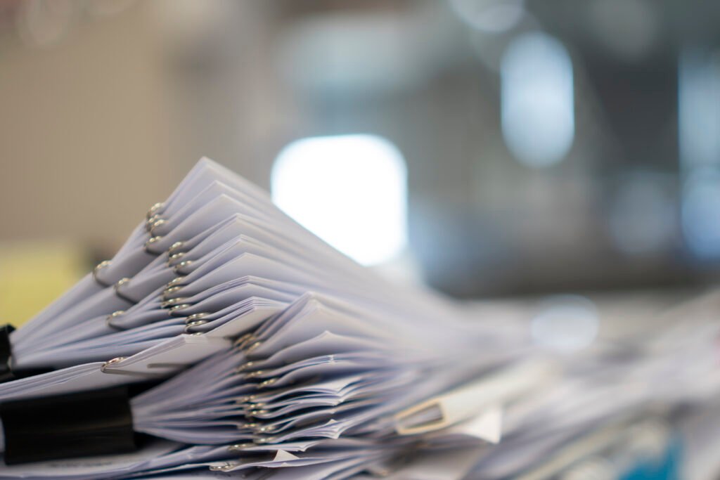 stack of paper, document, many jobs waiting to be done on the ta